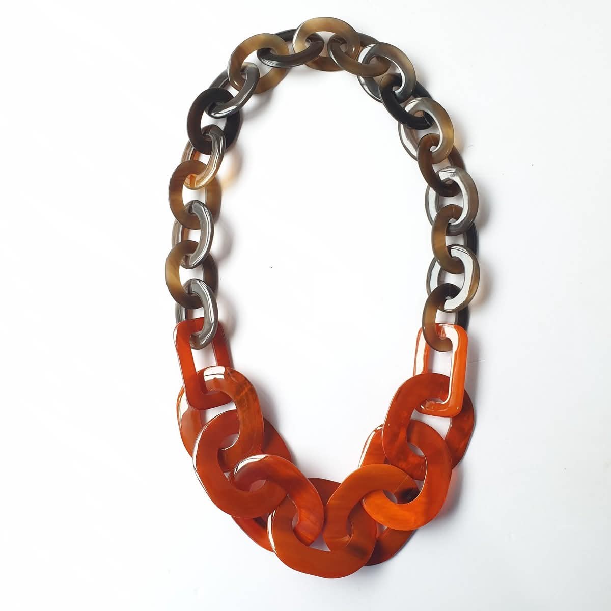 Statement necklace with orange and horn-toned links